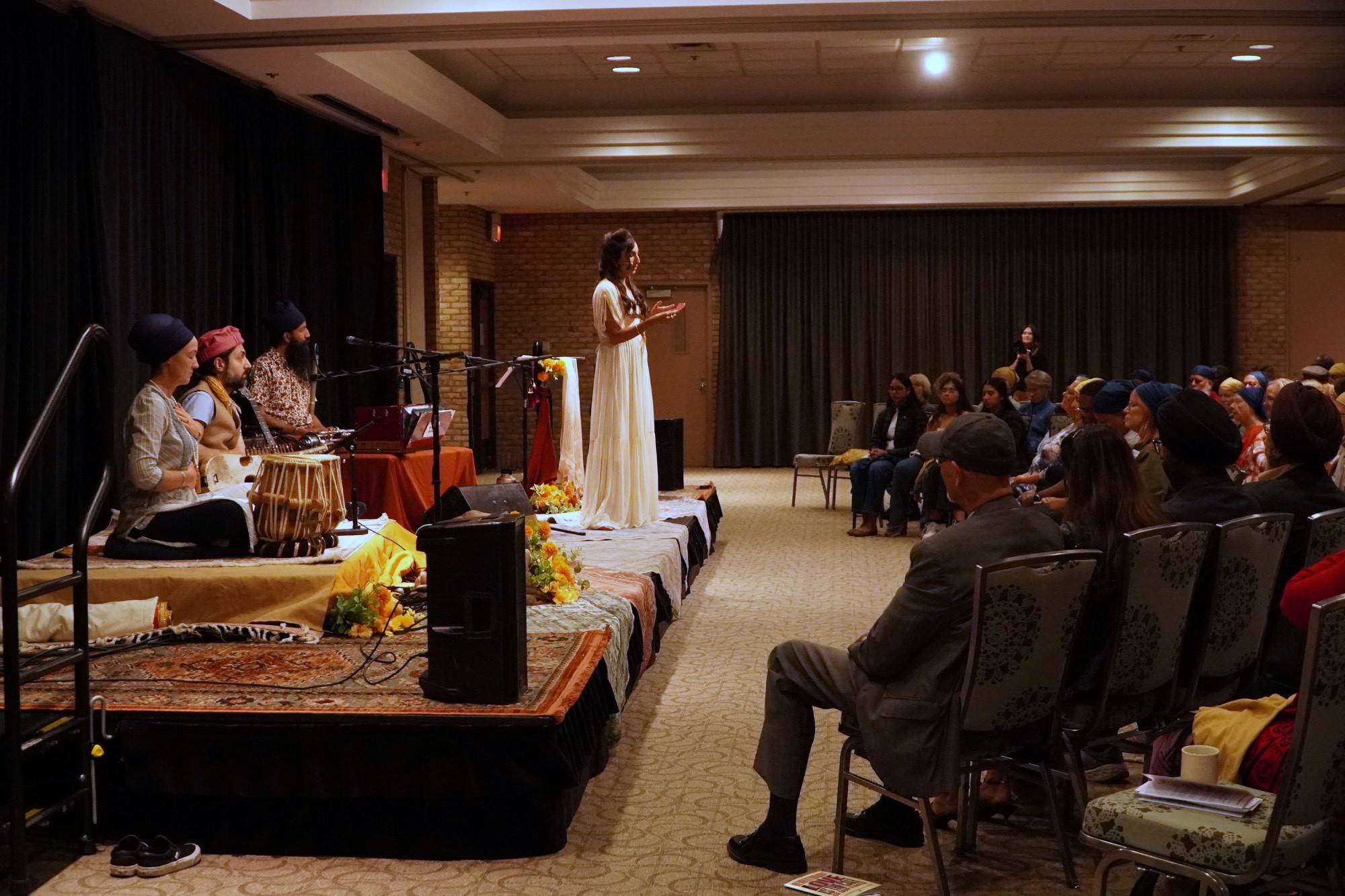 Valarie Kaur on stage with three musical preformers